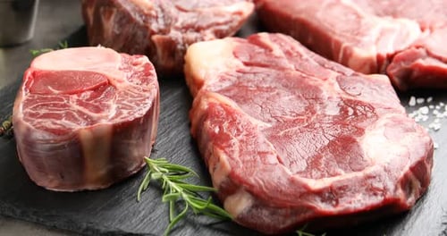 Fresh Raw Beef Steaks Assortment on Slate Board