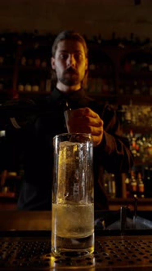 Bartender Pouring Sparkling Beverage Into Glass
