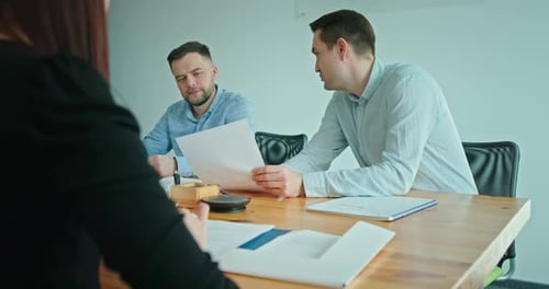 Team Reviewing Contracts in Bright Office Setting