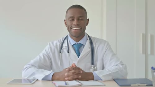 African Doctor Smiling at Camera While in Clinic