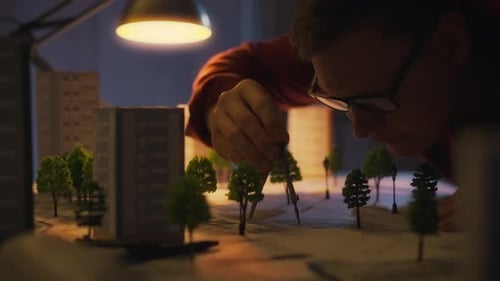 Architect Designing City Architectural Model with Compass