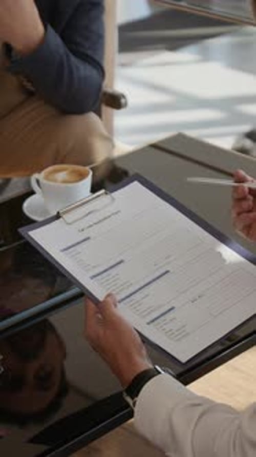 Businessmen Reviewing Documents at a Modern Workplace