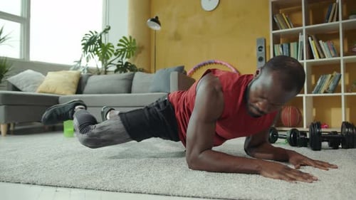 Man Doing Plank Exercise in Living Room