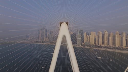 Aerial view of Ain Dubai Ferris wheel and cityscape by water, UAE.