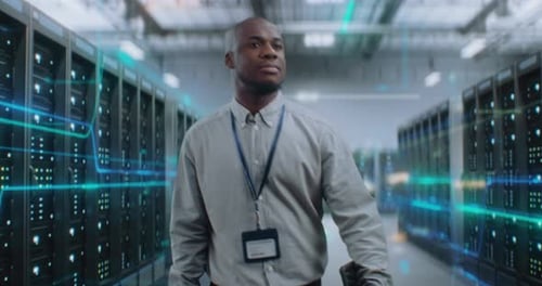 Administrator with Digital Tablet Walking in Futuristic Big Data Center with VFX