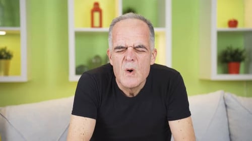 The old man is sweating from illness. High fever problem.