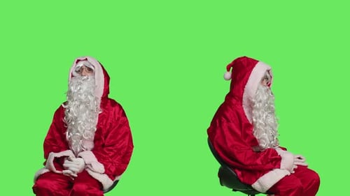 Two Men in Santa Suits Sitting on Green Screen