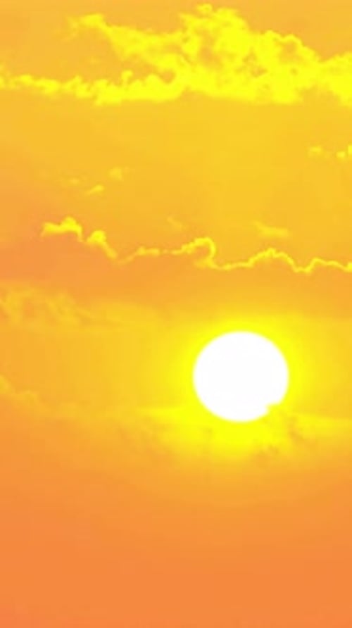 Vibrant Sunrise Ascends Through Fiery Orange Sky