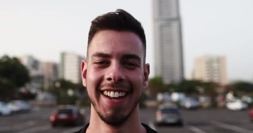 Smiling young man enjoying a sunny day in the city in the USA