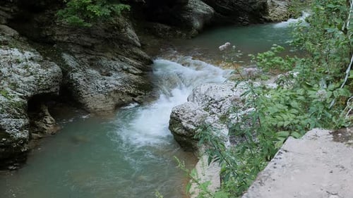 A Fast Mountain River in a Mountain Gorge Water Flows Over Large Stones