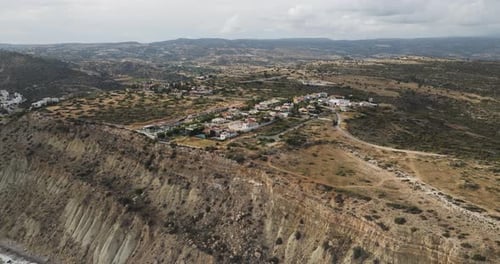 Aerial view of village on a cliff with hills, Cyprus.