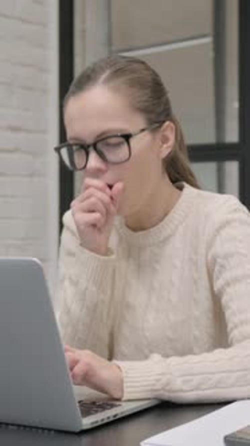 Woman Working on Laptop then Coughs at Desk