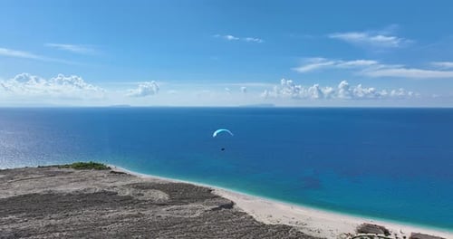 Paraglider Over Clear Blue Coastline