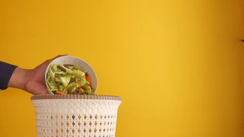 Throwing Vegetables in a Garbage Bin