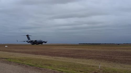 Boeing C-17A Globemaster III Cargo Plane Running In Low Speed On Airfield Tarmac. close-up, tracking