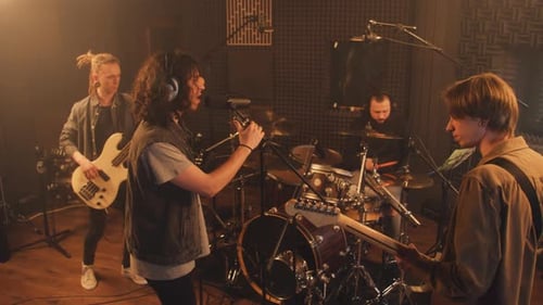 Musicians Play on Guitars and Drum Set