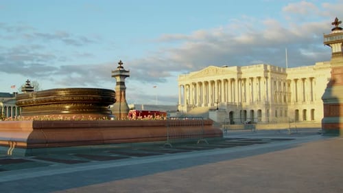 Flower beds in front of the US Capitol building wake up in the dawn sunlight