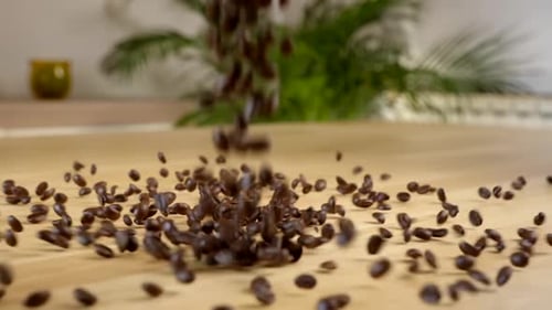 Roasted Coffee Beans Falling On A Wooden Table - close up, static shot