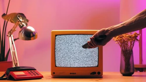 Hand Turns off Static Television with Remote