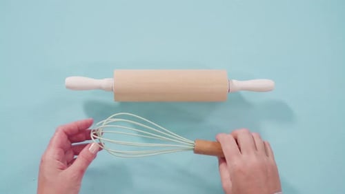 Rolling Pin and Whisk Removed on Blue Surface