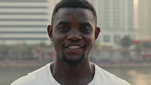 Portrait of African American Man Smiling on City Embankment