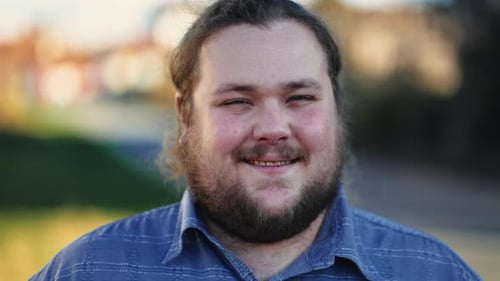 Closeup face of a positive casual male caucasian person with joyful expression