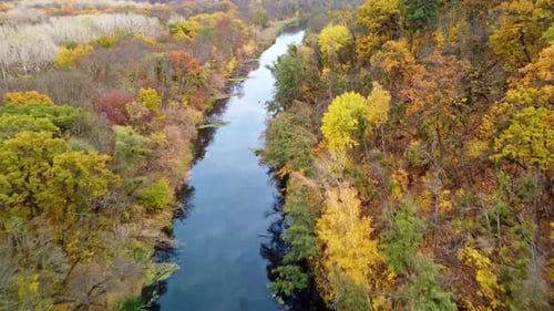 Autumn aerial above river with colorful riverbanks