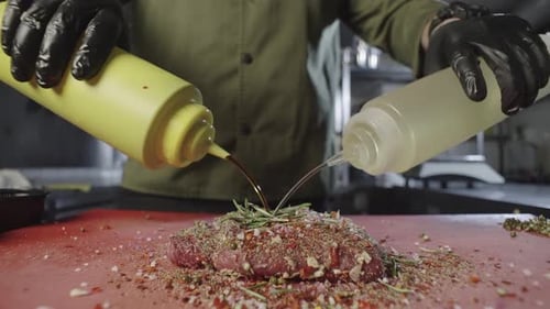 The Chef Adds Oils and Sauces to the Raw Meat Marinade