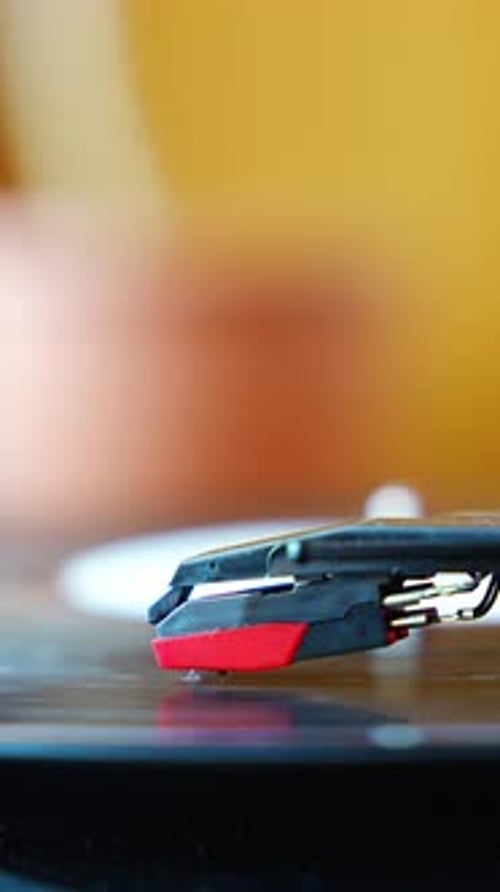 Closeup of Record Player Needle Tracking Vinyl Grooves During Playback Analog Sound Detail Capturing
