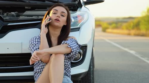 Woman Using Phone Next to Broken Down Car