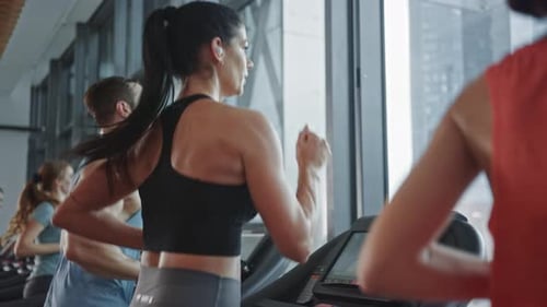 Beautiful Athletic Sports Woman Wearing Wireless Headphones, Listens to a Podcast or Sport Music Pl