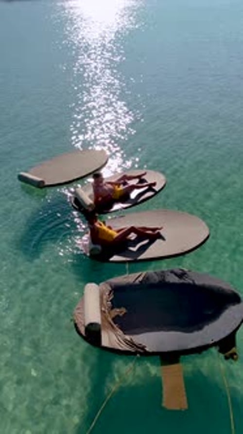 Relaxing on Floating Loungers in the Turquoise Waters of Koh Kood Island Thailand