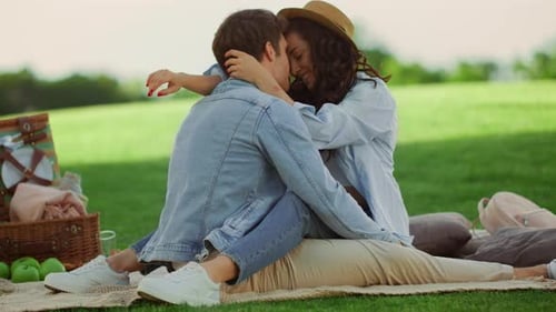 Loving couple embracing during beautiful picnic in park