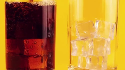 Soda Pouring Into Glass with Ice Cubes