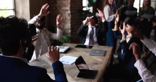 Business people wearing virtual reality goggles inside office