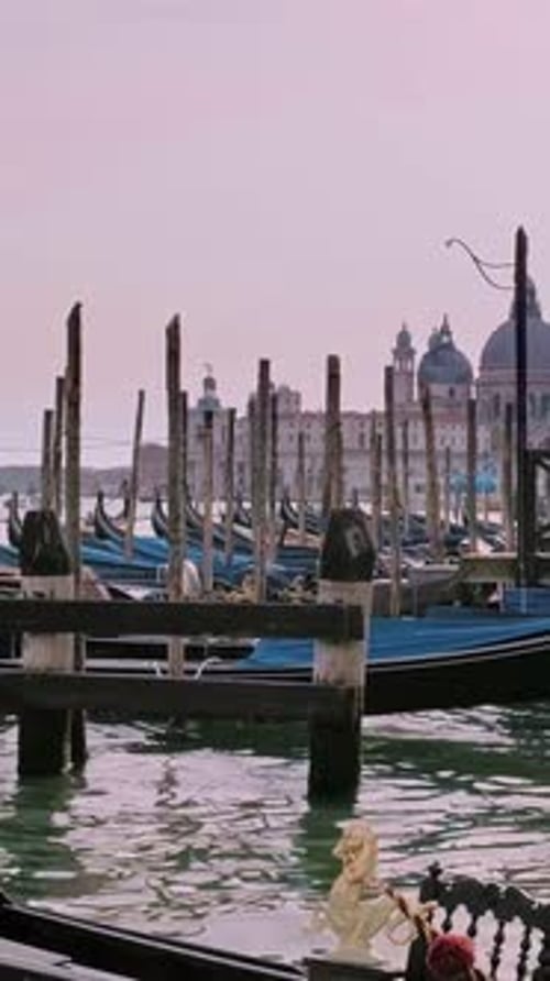 Tourists Enjoying Gondola Ride on Grand Canal Venice Italy at Day Moored Boats with Blue Covers Near