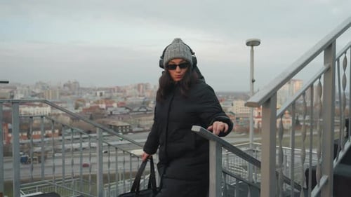 Energetic Woman Performs Dance on Rooftop Stairs Vibrant Woman in Sunglasses Motions Playfully on