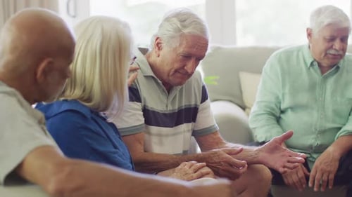 Mature Adults Consoling Each Other in Living Room