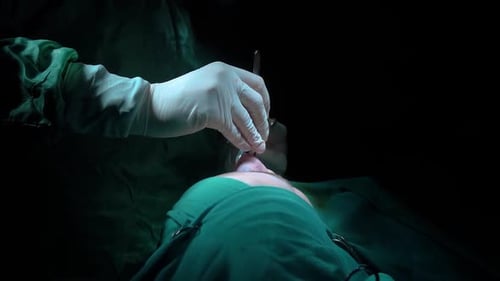 Rhinoplasty procedure and stitching doctor, end of operation.. Rhinoplasty procedure performed by a