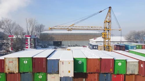 Shipping Container and Cargo Crane at Storage Yard at Winter Time Aerial View