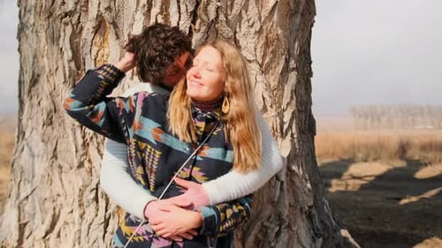 Romantic Couple Embracing by a Tree in Rural Setting