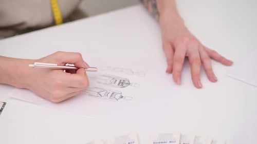 Woman Draws Dress Model Sitting at Desk in Clothes Atelier Talented Designer Makes Garment Sketch