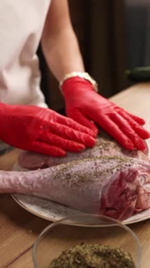 The chef prepares a dish of meat in the kitchen. Close-up