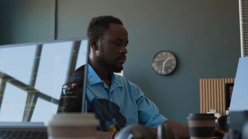 Bearded Black Programmer Working In Office