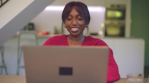 Young Adult Working on Laptop at Home