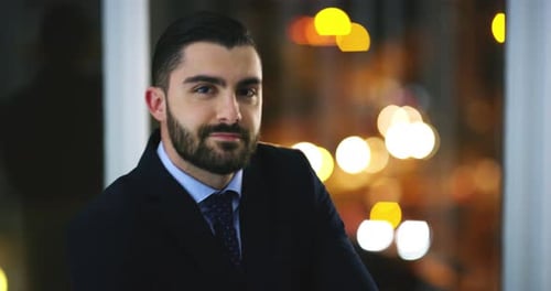Face, night and business man in office, confident and working on deadline in workplace