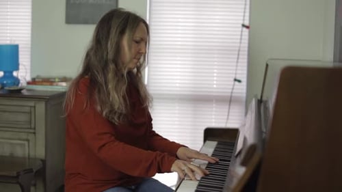 Woman Plays Piano with Focus and Grace