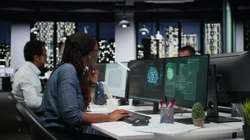 Panicked Female Engineer in Office Requests Help From Colleagues to Block Hacker