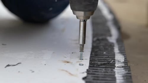 Screw Being Drilled Into Material With Drill
