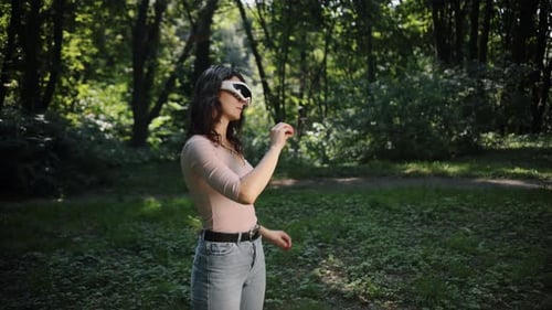 Young Woman Using VR Glasses in Park